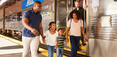 Family boarding a Metra train.